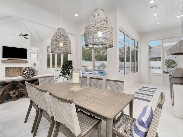 dining area with a towering ceiling and ceiling fan