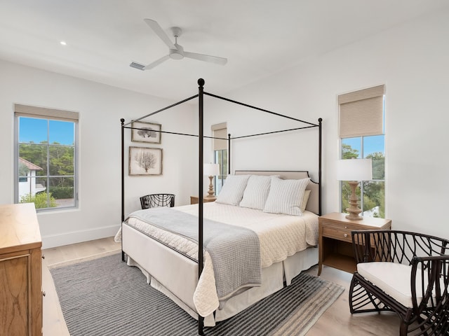 bedroom with ceiling fan and light hardwood / wood-style floors