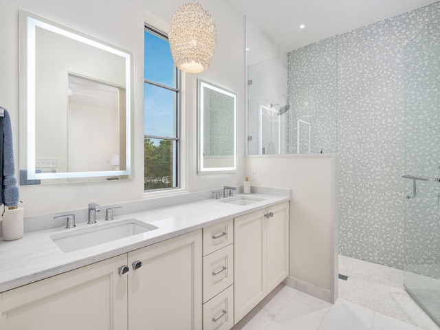 bathroom with vanity, tile patterned floors, an enclosed shower, and a notable chandelier