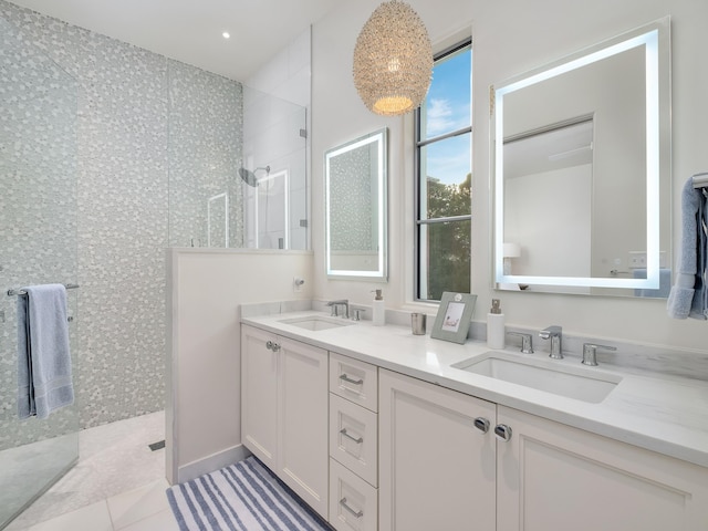 bathroom with a shower, vanity, and tile patterned flooring