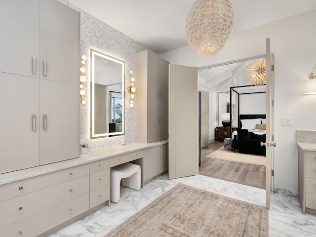 bathroom featuring vanity and vaulted ceiling