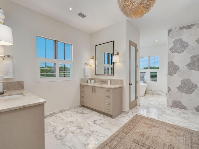 bathroom with vanity and a bathtub