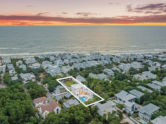 aerial view at dusk with a water view