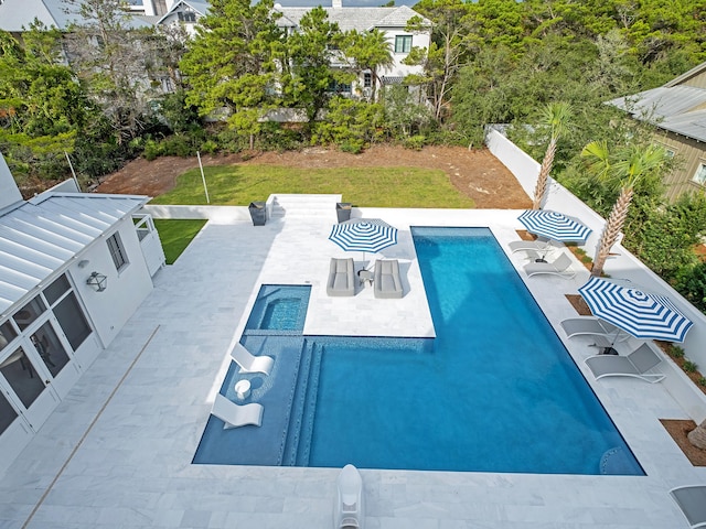 view of pool with a lawn and a patio area