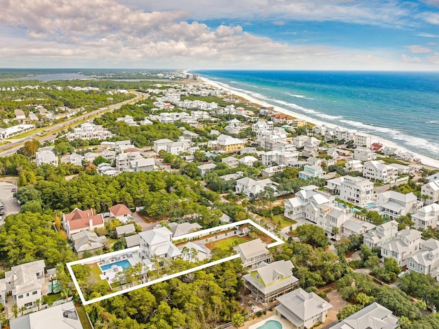 bird's eye view featuring a water view and a view of the beach