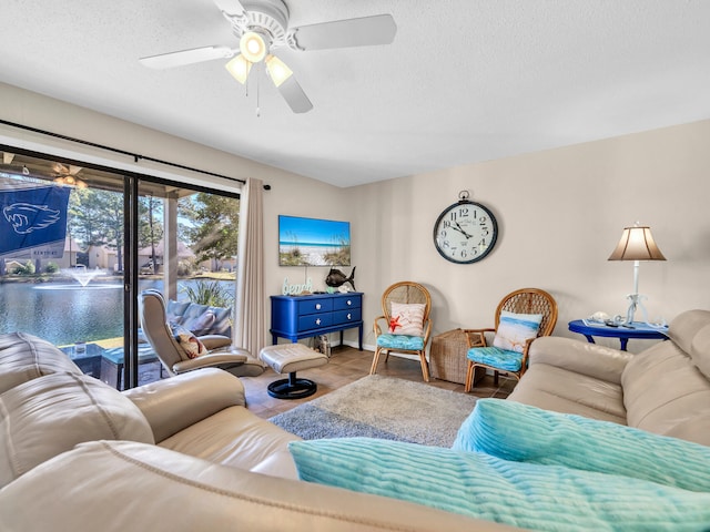 tiled living room with a textured ceiling and ceiling fan