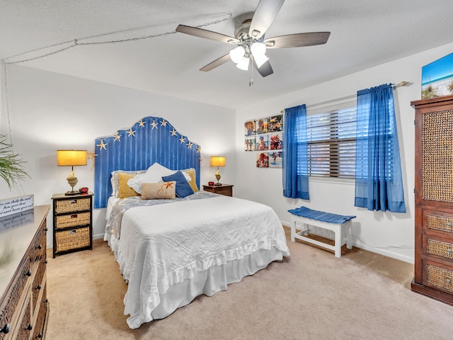 carpeted bedroom with ceiling fan and a textured ceiling