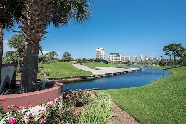 surrounding community featuring a water view, a city view, and a lawn