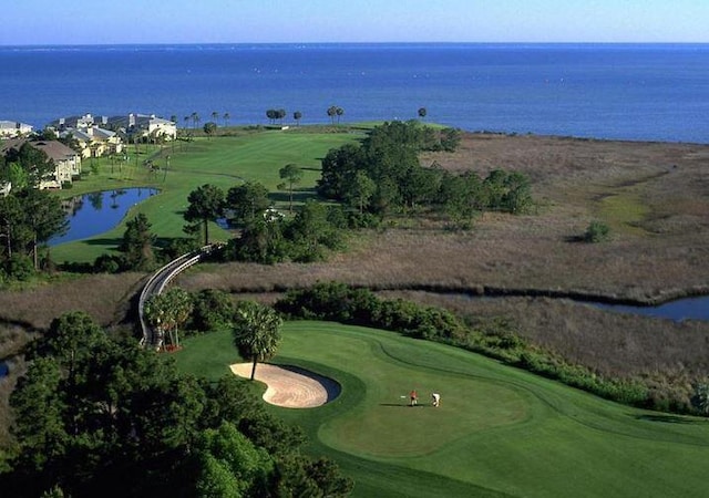 bird's eye view featuring a water view and view of golf course