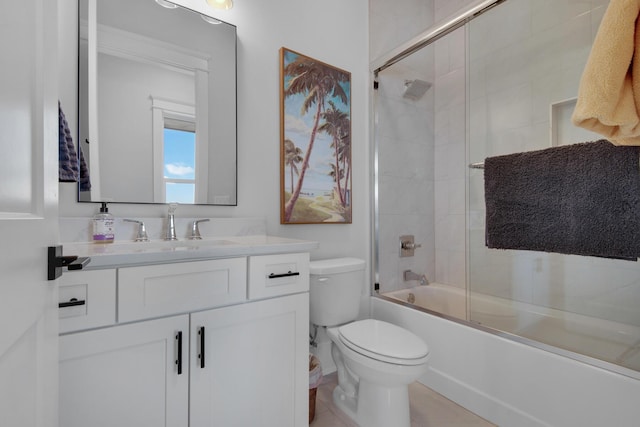 full bath with vanity, toilet, and shower / bath combination with glass door