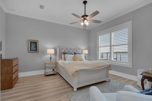 bedroom with visible vents, crown molding, ceiling fan, baseboards, and light wood-style floors