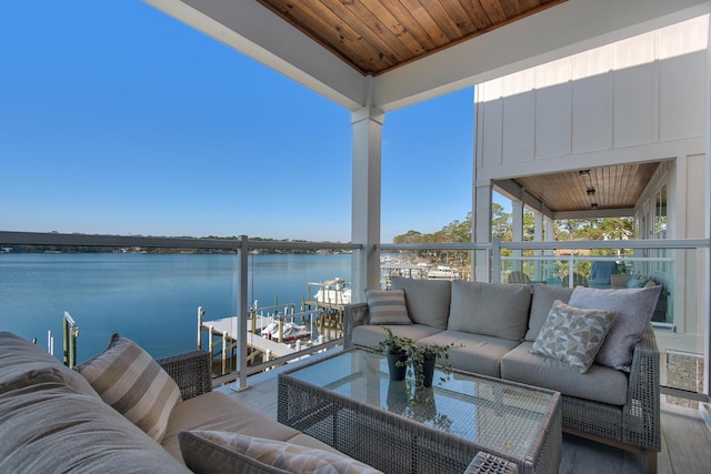 exterior space featuring an outdoor hangout area, a dock, and a water view