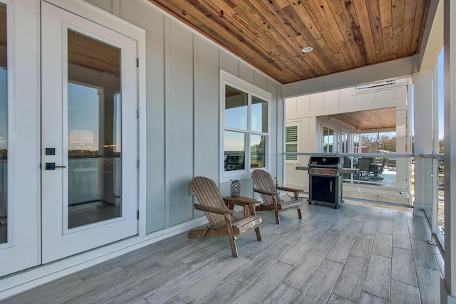 wooden terrace featuring a grill