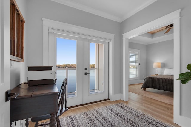 interior space with ceiling fan, french doors, light wood-style floors, and ornamental molding