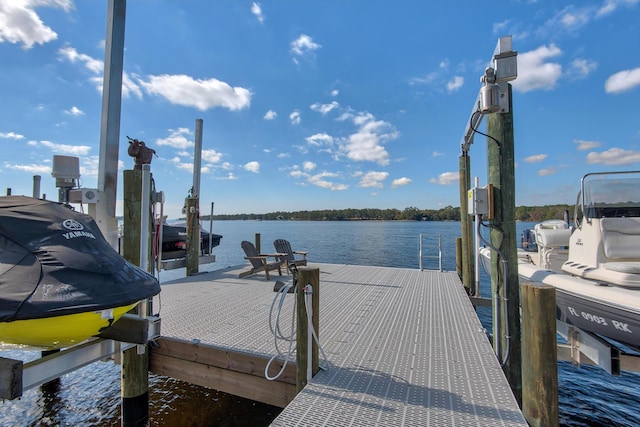 dock area with boat lift and a water view