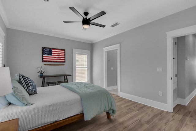 bedroom with visible vents, wood finished floors, and ornamental molding