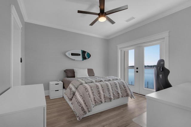 bedroom with visible vents, crown molding, light wood-style floors, and access to outside