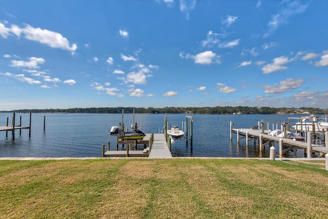 view of dock with boat lift, a yard, and a water view