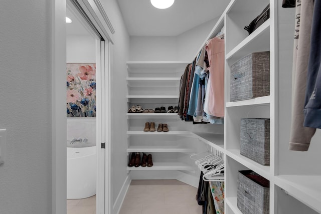 spacious closet featuring light tile patterned floors