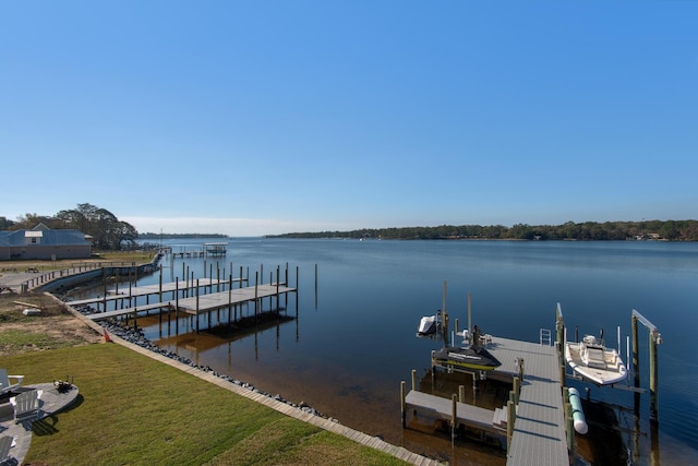 view of dock with a yard, a water view, and boat lift