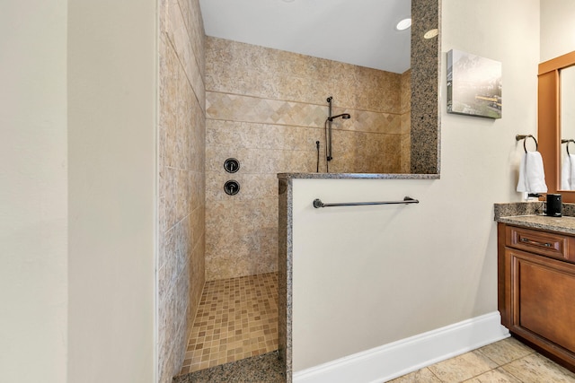 bathroom featuring a tile shower and vanity