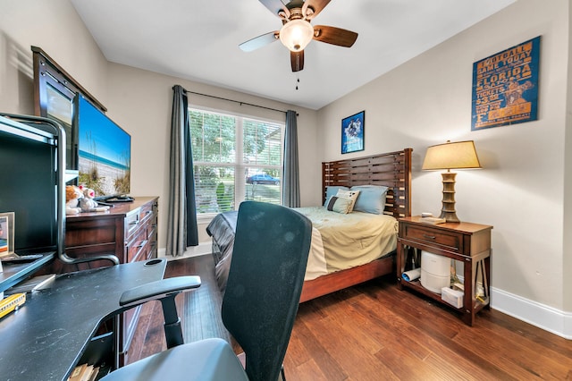 bedroom with dark hardwood / wood-style floors and ceiling fan