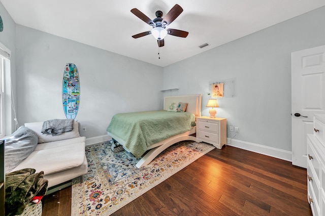 bedroom with ceiling fan and dark wood-type flooring