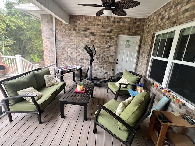 deck with an outdoor living space and ceiling fan