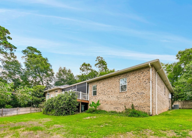 back of house featuring a yard, a deck, and cooling unit