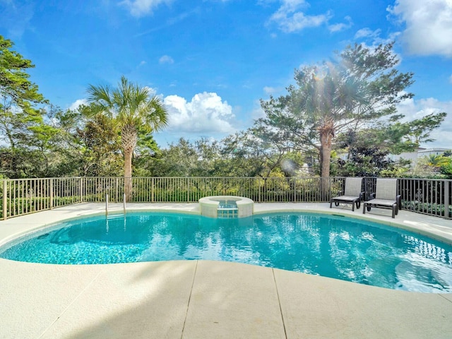 view of swimming pool featuring an in ground hot tub and a patio area