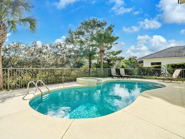 view of swimming pool with an in ground hot tub and a patio area