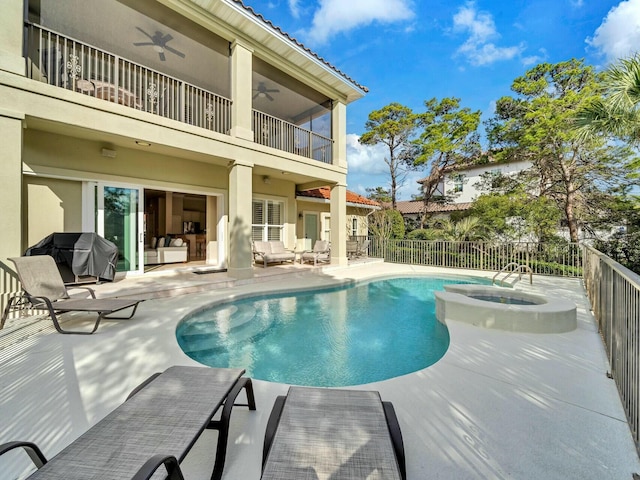 view of pool with ceiling fan, area for grilling, an in ground hot tub, and a patio