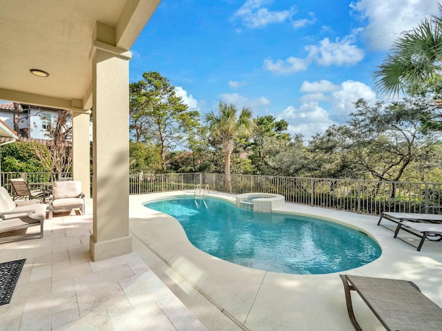 view of pool with a patio area and an in ground hot tub