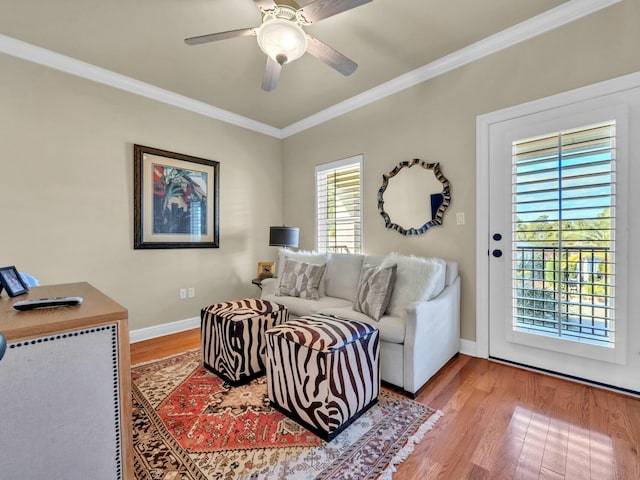 living room featuring ceiling fan, crown molding, and hardwood / wood-style floors