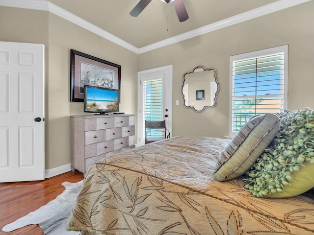 bedroom featuring hardwood / wood-style floors, ceiling fan, access to exterior, ornamental molding, and multiple windows