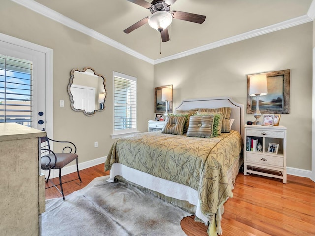 bedroom with ceiling fan, hardwood / wood-style flooring, and crown molding