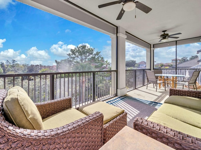 sunroom / solarium featuring ceiling fan