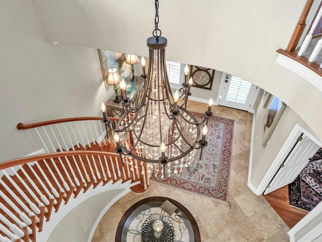 stairs with an inviting chandelier