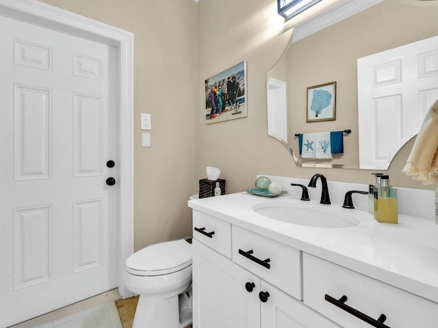 bathroom with tile patterned floors, vanity, and toilet