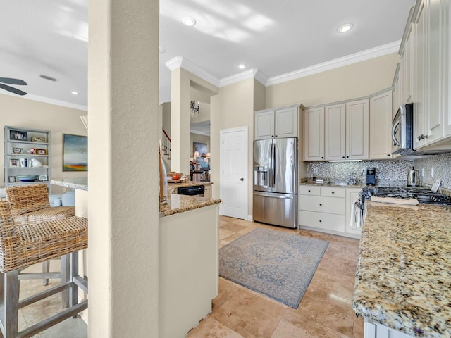 kitchen with stainless steel appliances, decorative backsplash, ornamental molding, white cabinets, and light stone counters