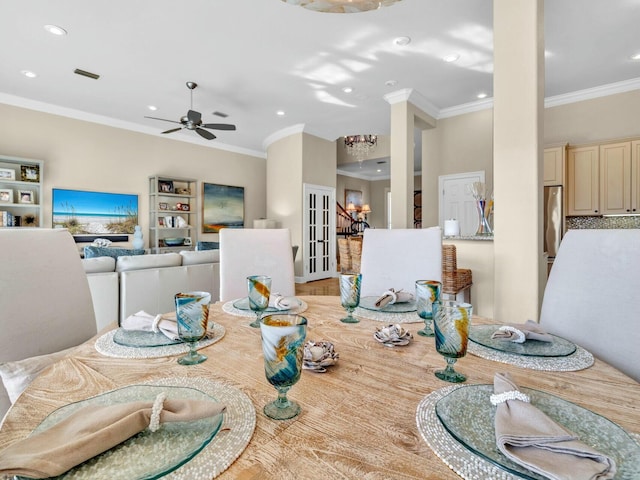 dining area with ceiling fan and ornamental molding