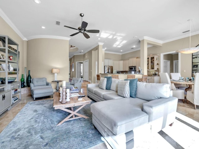 living room featuring ceiling fan and crown molding