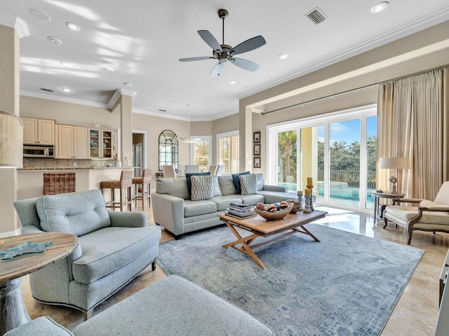 living room featuring ceiling fan and crown molding