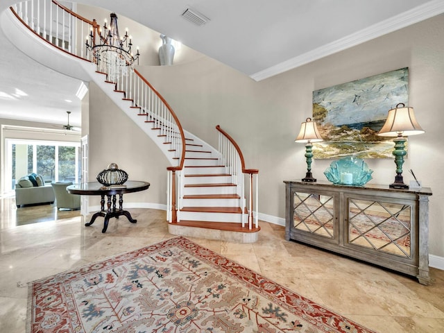 interior space with a chandelier and crown molding