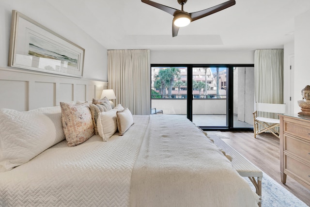 bedroom featuring ceiling fan, light hardwood / wood-style floors, and access to exterior