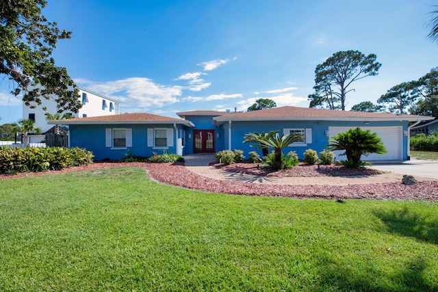 single story home with french doors, a garage, and a front lawn