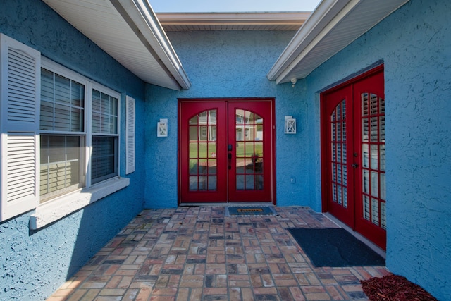 view of exterior entry featuring a patio area and french doors