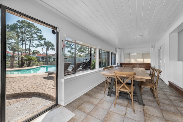 sunroom / solarium featuring french doors and wood ceiling