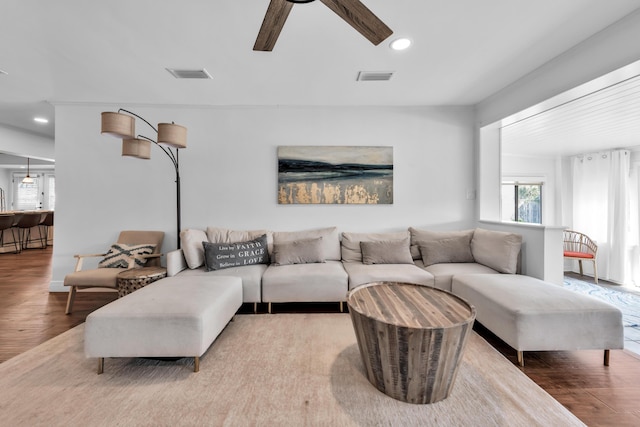 living room featuring ceiling fan and light hardwood / wood-style floors