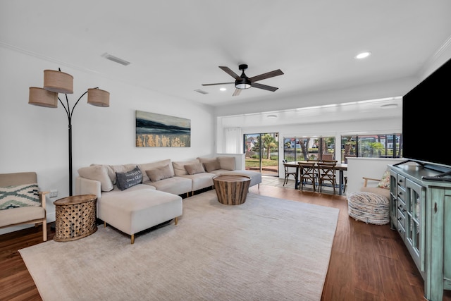 living room with ceiling fan and dark wood-type flooring